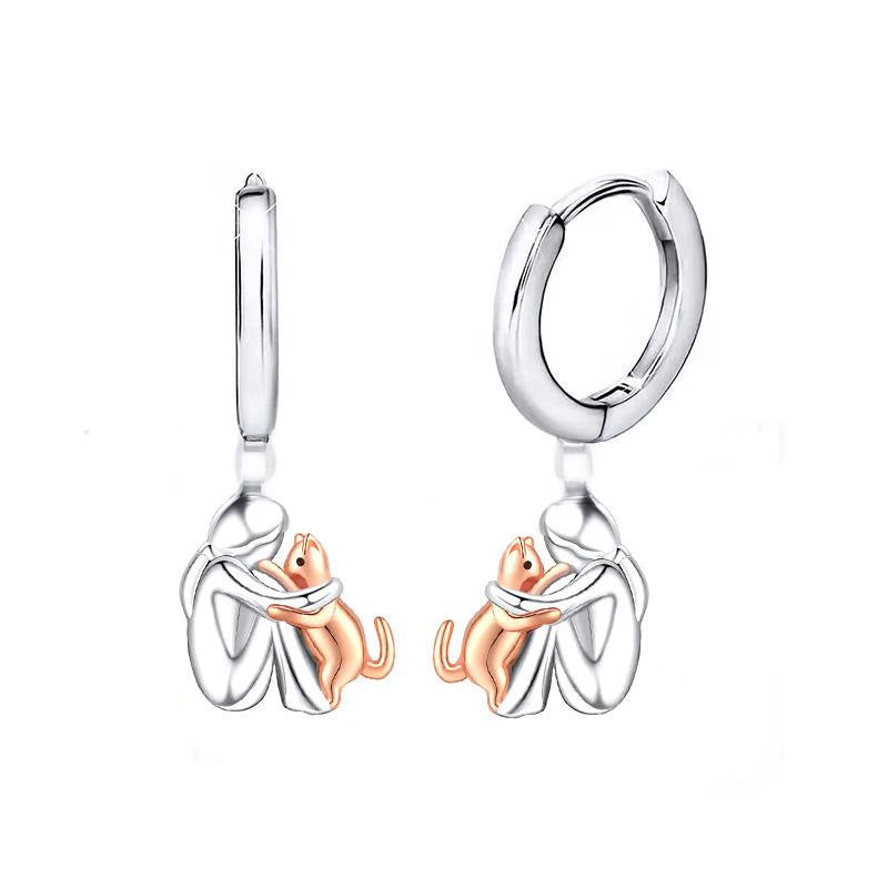 Petite Fille Câlinant un Chien – Clous d’Oreilles et Collier